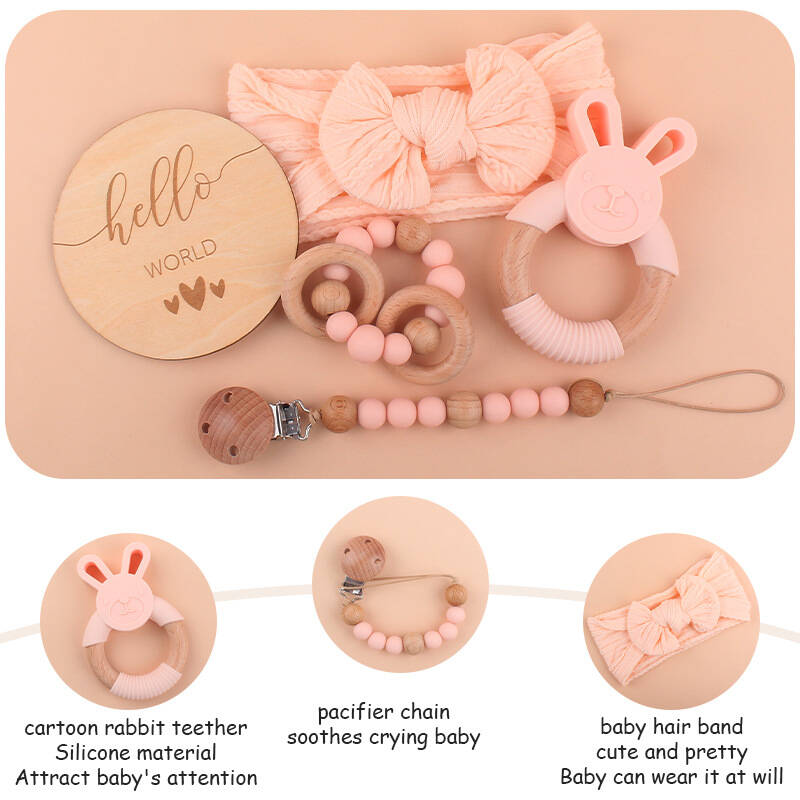 baby with wooden rattle