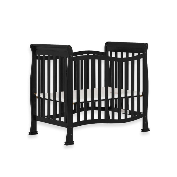 An adventurous toddler looking like they are about to climb out of their crib