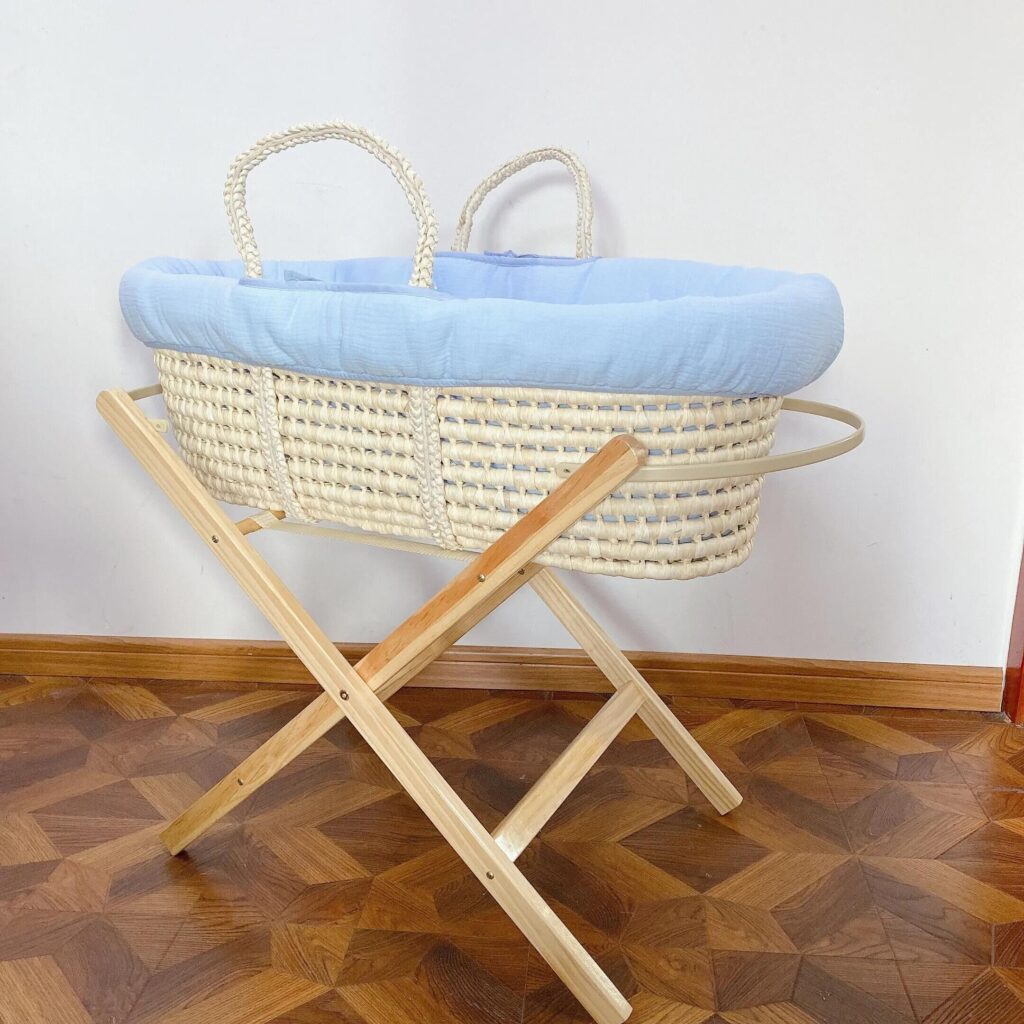 A shaky, ill-fitting Moses basket on a stand highlighted with a warning symbol