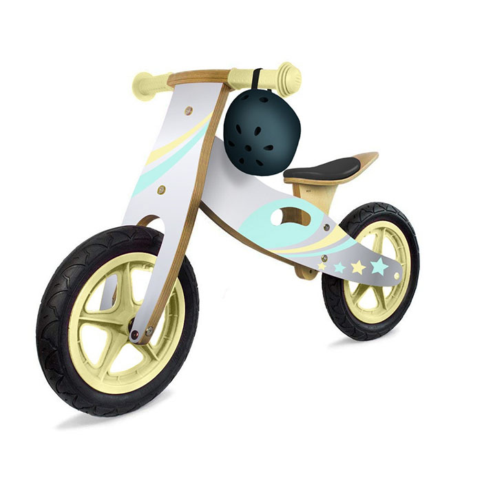 A well-merchandised retail display of colorful wooden balance bikes