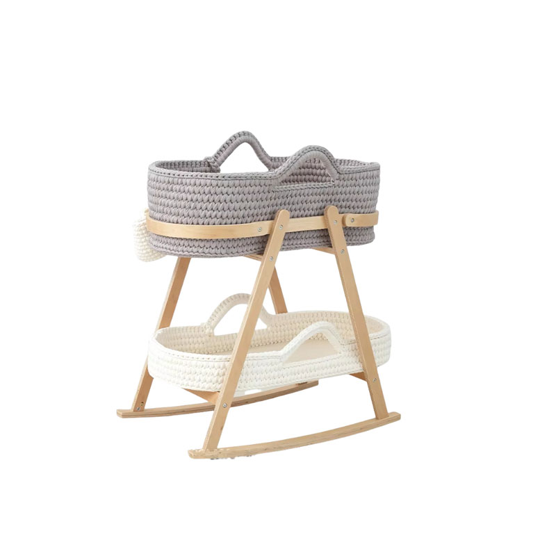 A correctly fitted Moses basket on its stand next to an ill-fitting, wobbly one with a warning sign