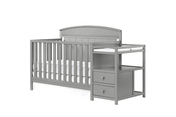 A changing table with a safety strap and organized supplies
