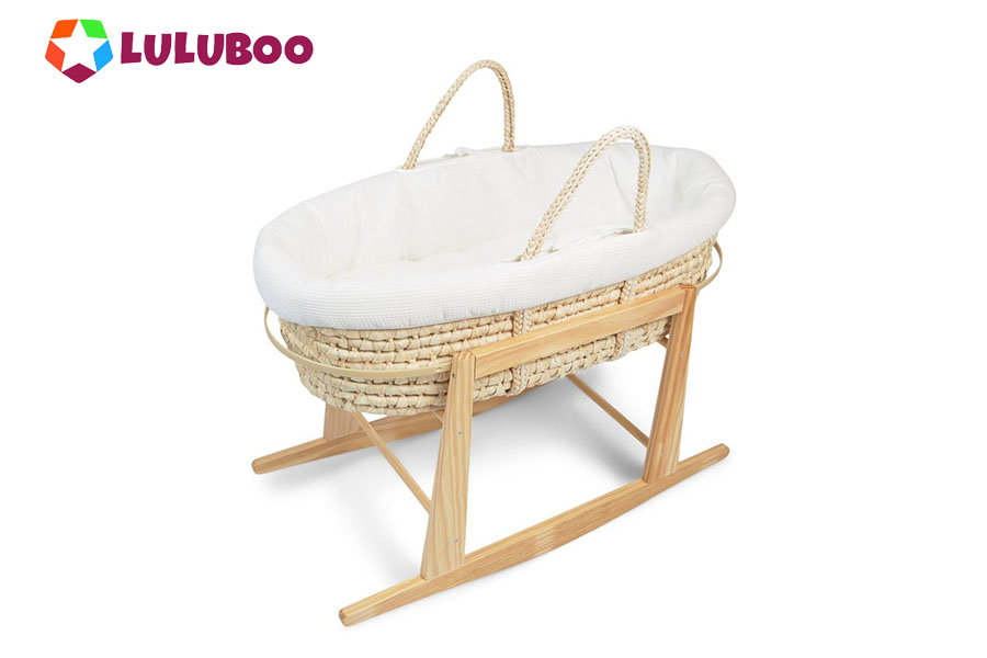 A chic retail display showing a complete Moses basket set with accessories
