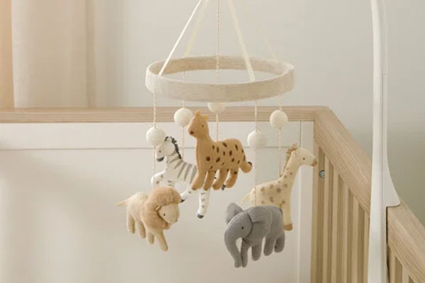 A colorful, gentle crib mobile hanging safely above a crib