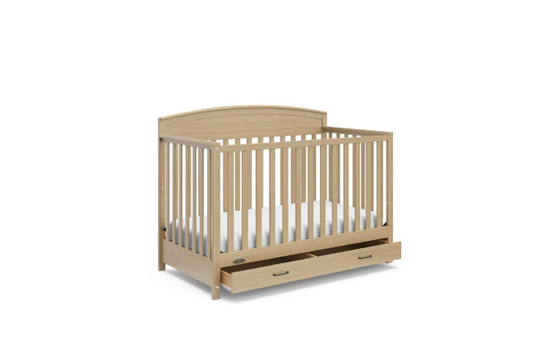 A modern baby cot in a nursery with Australian animal toys
