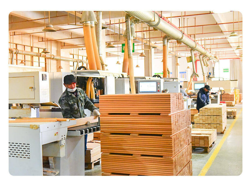 A shipping container being loaded at a modern factory in Asia