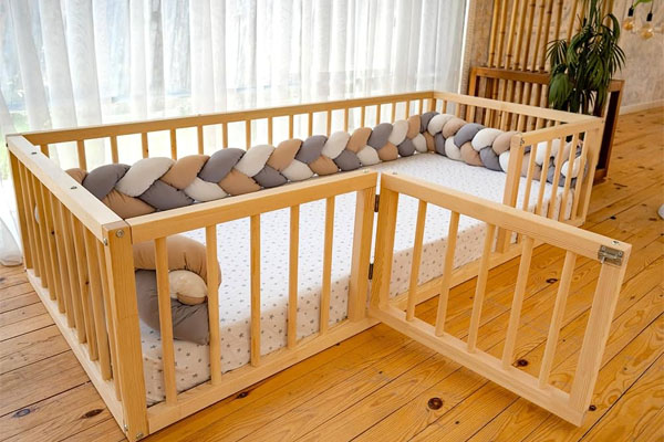 A toddler waking up and safely getting out of a floor bed in a child-proofed room