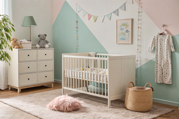 An IKEA crib in a room, with a question mark over the Greenguard Gold logo
