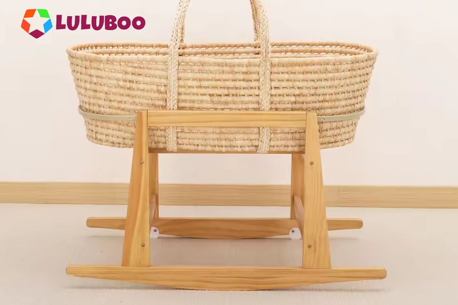 An eco-friendly Moses basket made of natural maize husk on a solid pine wood stand