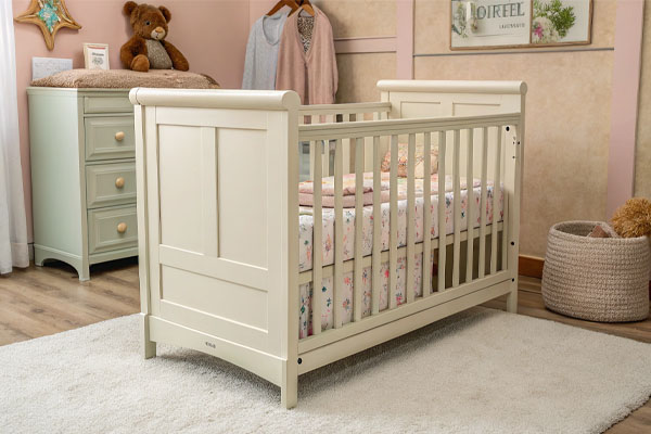 An illustration of an American family pointing to a baby crib and saying crib
