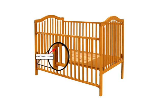 An old-fashioned drop rail crib with a large red prohibition sign over it