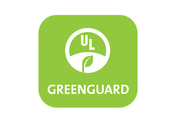 The Greenguard Gold certification logo displayed on a baby crib tag