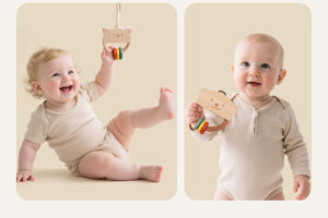 A baby doing tummy time on a playmat, reaching for a colorful wooden rolling toy