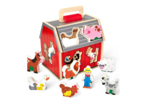 The FSC certification logo displayed next to a beautiful wooden toy barn